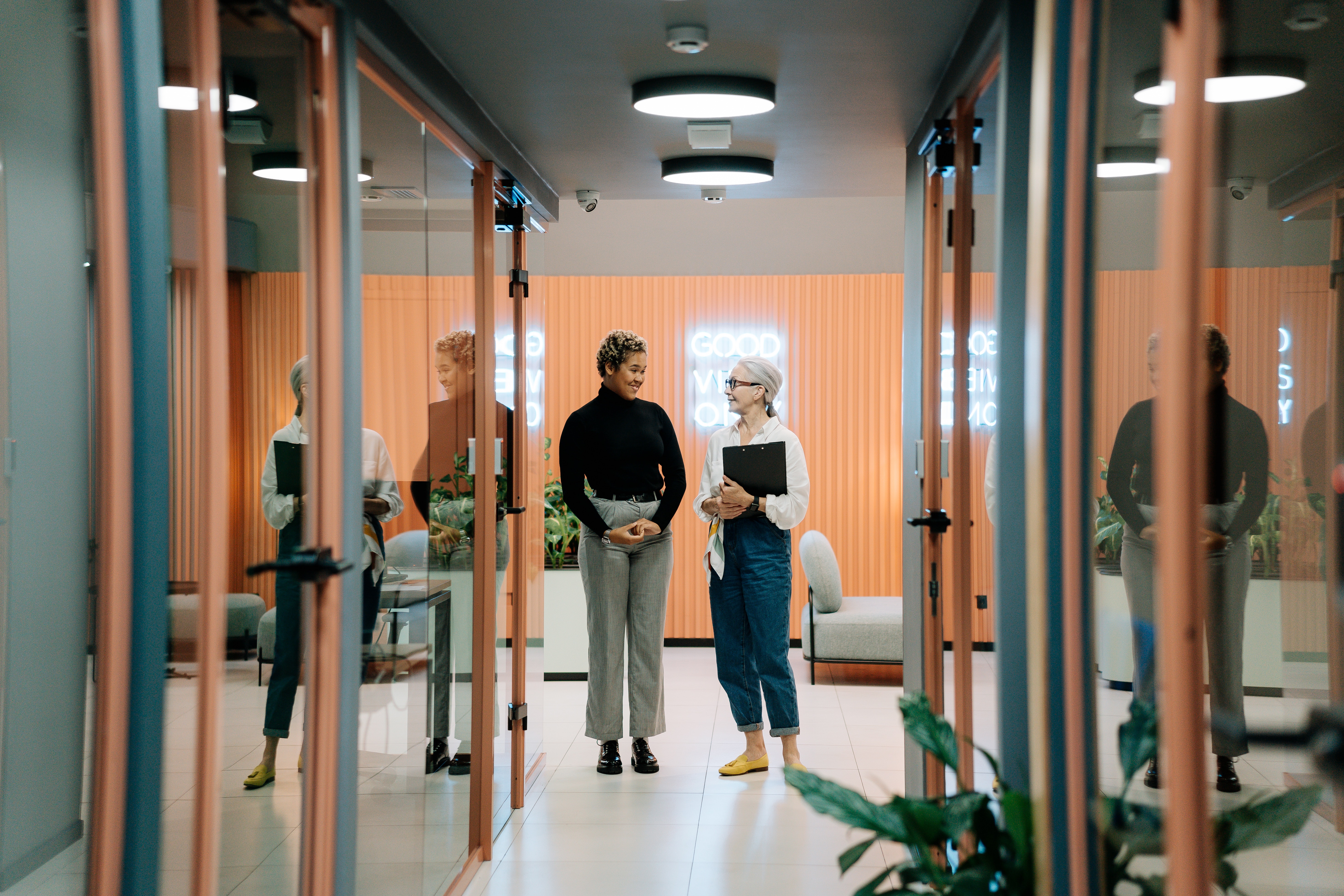 two people talking in an office hallway