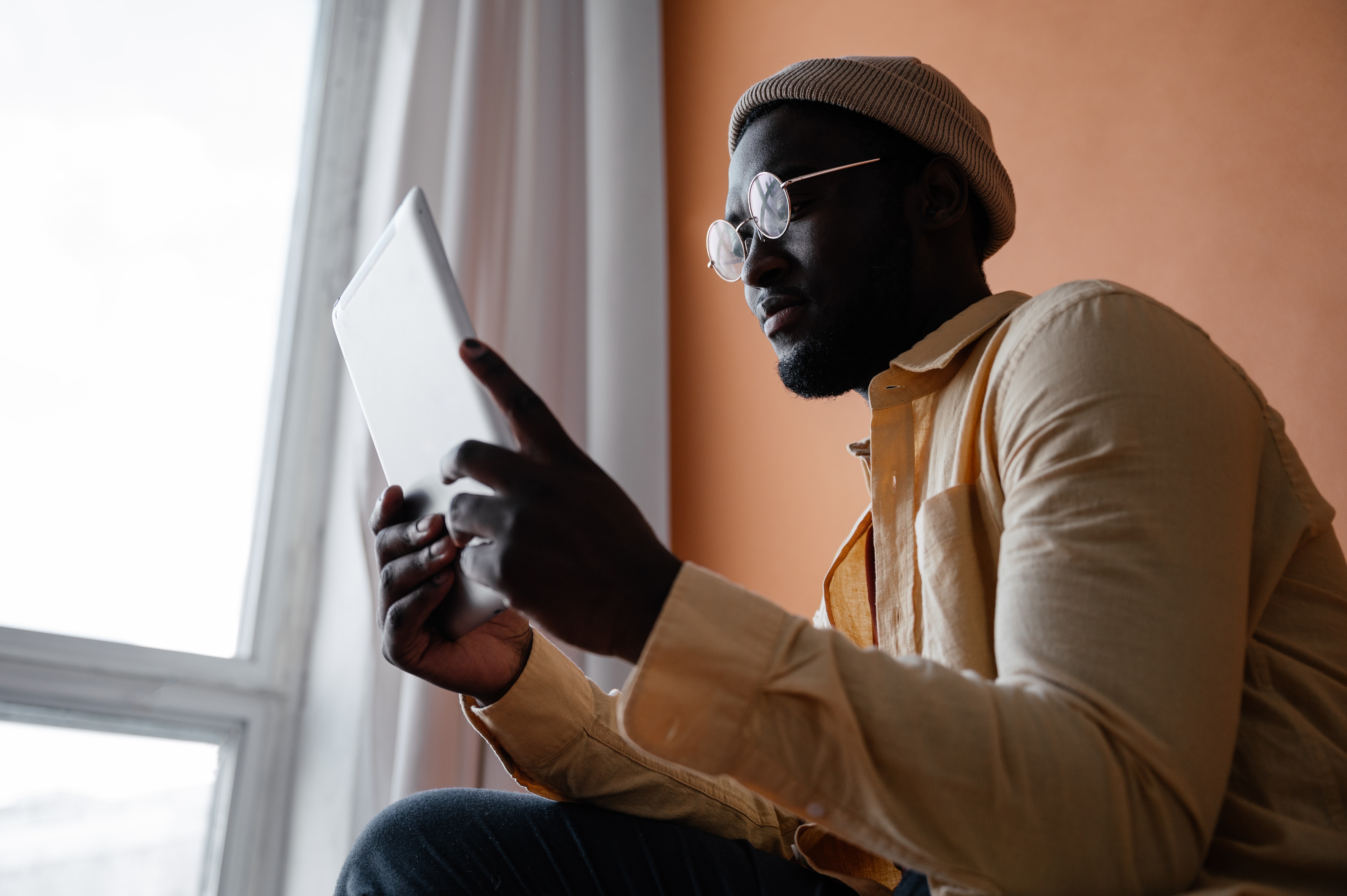 a person holding up a tab