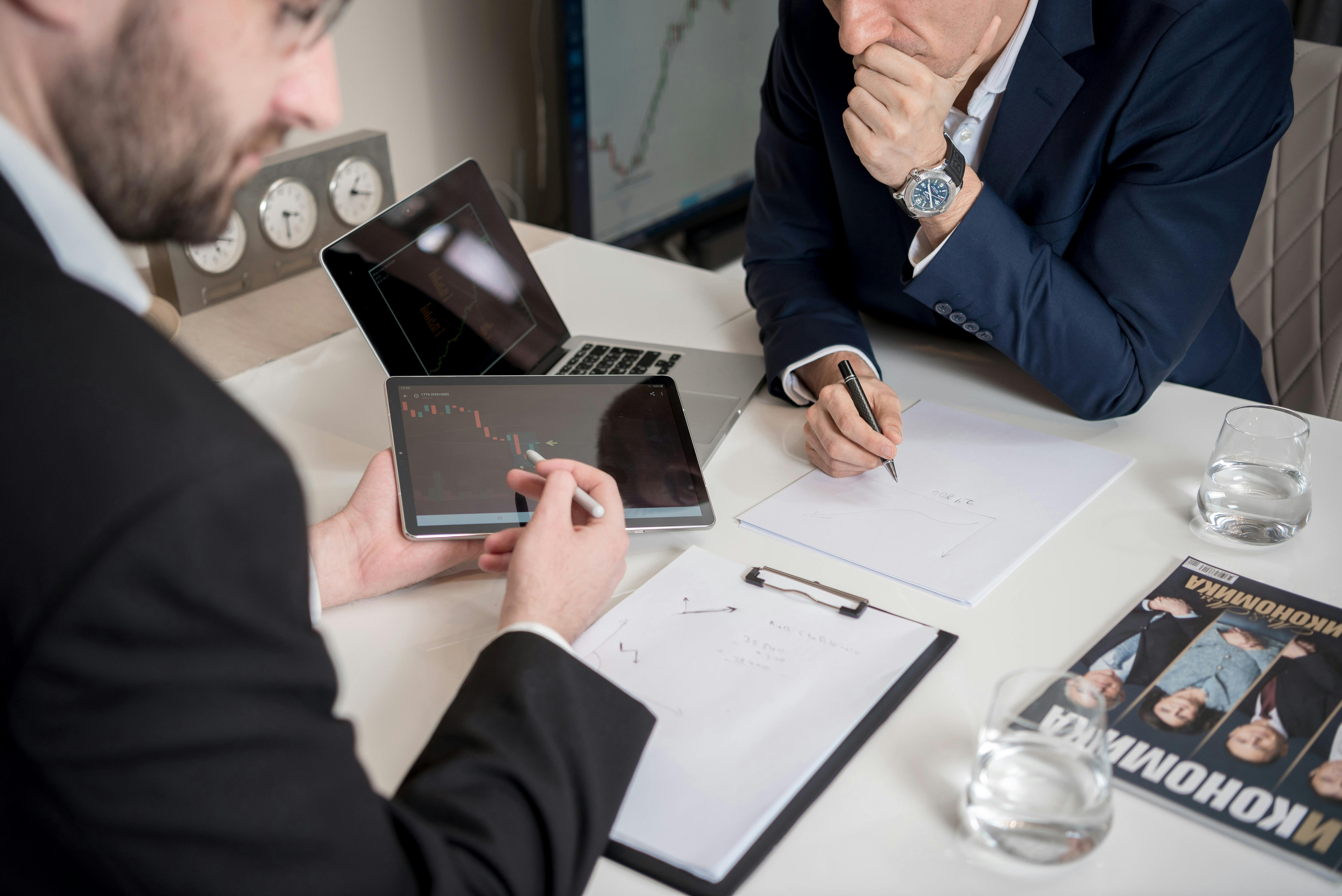 two workers contemplating over an accounting report