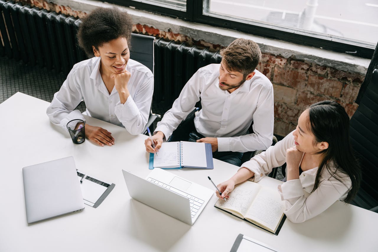 three employees having a meeting